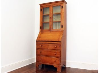 An Antique Pine Secretary Desk With Glass Display Cabinet Atop A Chest