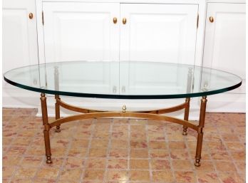 An Oval Glass And Brass Cocktail Table