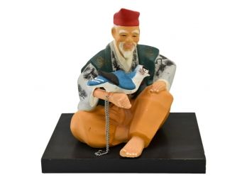 Chinese Man With Bird Pottery Sculpture