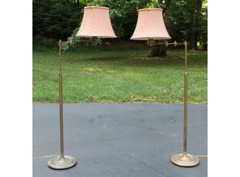 A Pair Of Adjustable Height Brass Standing Lamps With Striped Shades