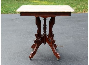 An Antique Marble Top Side Table In Eastlake Style