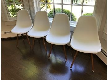 Four White Plastic Chairs