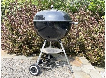 A Weber Charcoal Grill And Accessories