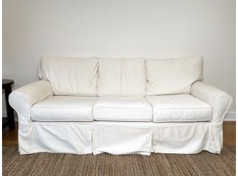 A Linen Slipcovered Sofa By Pottery Barn