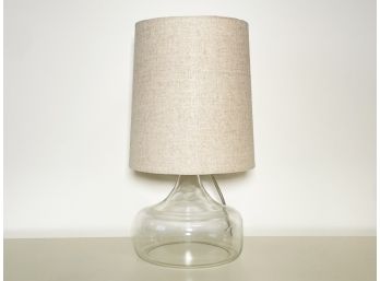 A Blown Glass Lamp With Linen Shade