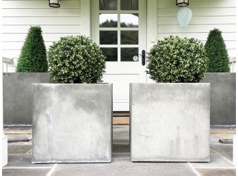 A Pair Of Modern Brutalist Cast Planters With Faux Foliage