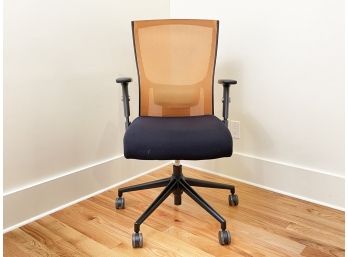 A Modern Ergonomic Office Chair With Orange Mesh Seat Back 2 Of 2