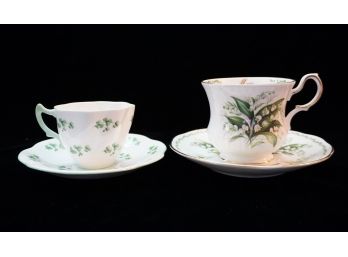 Two White And Green Tea Cups With Saucers
