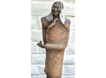 Tall Red Clay Sculpture From JJ Boone By Land Spurger Of A Native Figure Holding A Peace Pipe