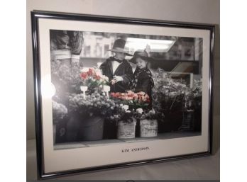 Photograph By Kim Anderson Of Well Dressed Boy And Girl Admiring Roses.