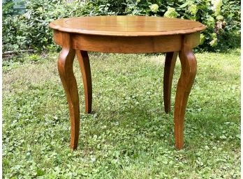 An Extendable Dining Table In Walnut Finish