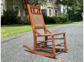 A Child's Oak And Cane Rocker