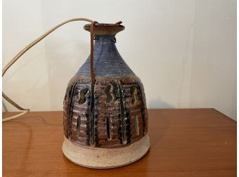 A MIDCENTURY MODERN HANGING POTTERY LAMP DATED 1967