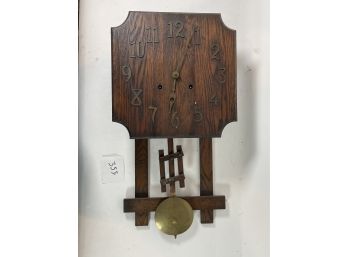 AN ARTS AND CRAFTS MISSION OAK WALL CLOCK BY THE NATIONAL CLOCK CO.