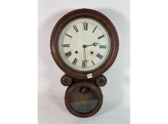 AN ANTIQUE WALNUT WALL CLOCK