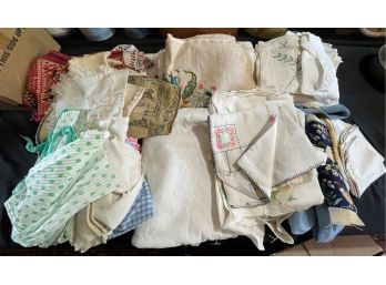 A BOX OF VINTAGE TABLE CLOTHES