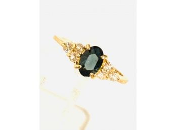 Gold Tone Ladies Size 4 Ring With Dark Blue Stone