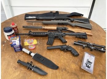 A Large Assortment Of Air Guns, Knives, And Sporting Accessories