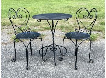 A Wrought Iron Bistro Set