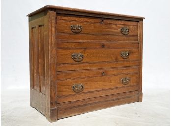 An Antique Paneled Oak Chest Of Drawers