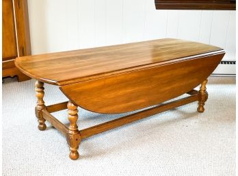 A Hard Wood Drop Leaf Coffee Table By Ethan Allen