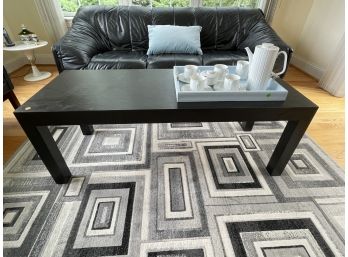 A SMALL BLACK COFFEE TABLE WITH FAUX SLATE FINISH