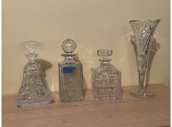 THREE DECANTERS AND A VASE