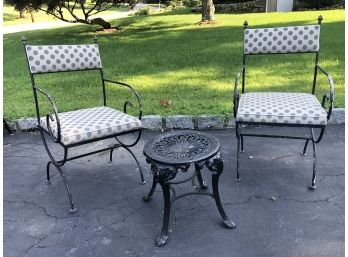 Pair Of Outdoor Iron Chairs With Polka Dot Cushions And A Round Metal Table