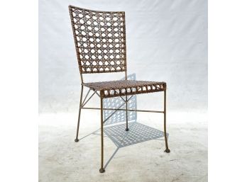 A Cane And Wrought Iron Chair