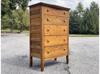 An Antique Paneled Oak Chest Of Drawers By Bernhardt Furniture