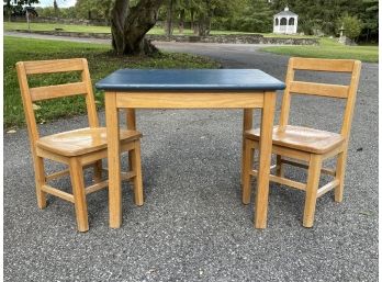 An Oak Child's Play Or Work Table And Chair Set