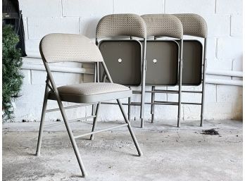 A Set Of 4 Vinyl Covered Metal Folding Chairs