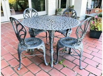 An Antique Cast Iron Dining Table And 4 Chairs