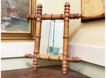 An Antique Bamboo Framed Mirror