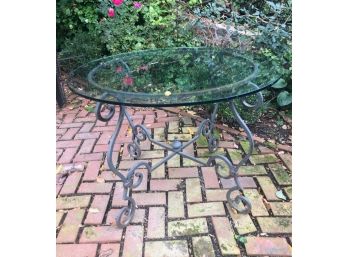 A Vintage Wrought Iron Side Table With Glass Top