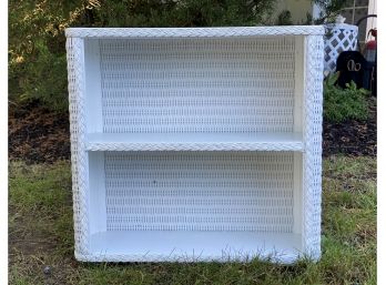 A Wall-Hung Shelf Unit In White Wicker