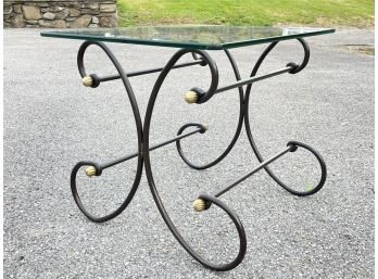 A Wrought Iron Table With Glass Top