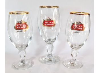3 Stemmed Original Stella Artois Beer Glasses With A Golden Rim 2.5x7' And 2.5x8'