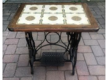 SEWING MACHINE BASE TABLE WITH CERAMIC TILE TOP.