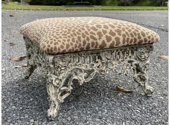 An Antique Cast Iron Upholstered Footstool With Faux Animal Print