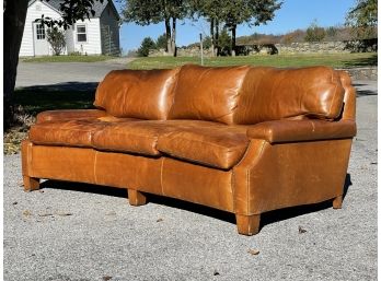 A Gorgeous Bow Backed Tawny Leather Sofa With Nailhead Trim By ABC Carpet & Home