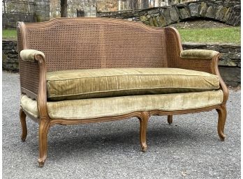 A Vintage Fruitwood And Cane Causeuse With Velvet Upholstery