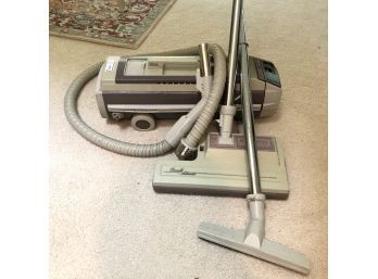 A Vintage Electrolux Canister Vacuum With Accessories