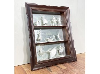 A Curio Shelf With Swan Lake Porcelain Figures