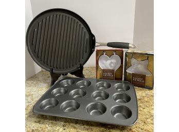 Kitchen Lot- Round 13-1/2' Calphalon Grill Pan, 2 Williams-sonoma Pocket Pie Molds, 1 Unbranded Muffin Tin