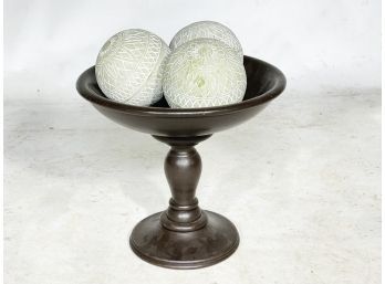 A Raised Fruit Bowl With Decorative Spheres