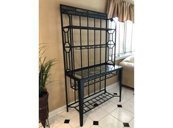 A Black Metal Bakers Rack With Decorative Stone Tile Under Glass Shelf