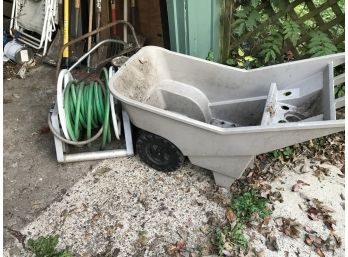 Plastic Wheel Barrow And Garden Hose And Reel