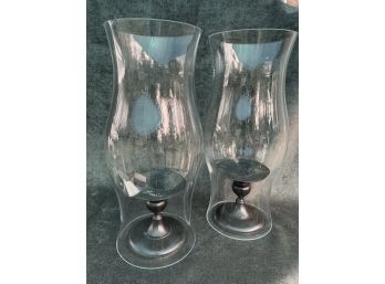 Two Candle Stick Holders With Large Glass Surrounds