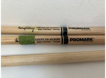 A Set Of Promark Drum Sticks With An Extra Odd One